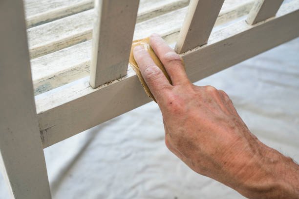 Maintaining a gate with paint, part of expert garage door repair and maintenance services in Pasadena.