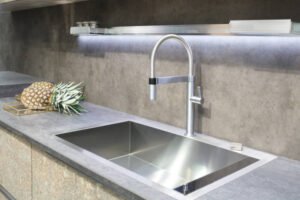 A contemporary kitchen equipped with a stainless steel sink and counter, emphasizing a clean and modern design with a premium stainless steel sink.
